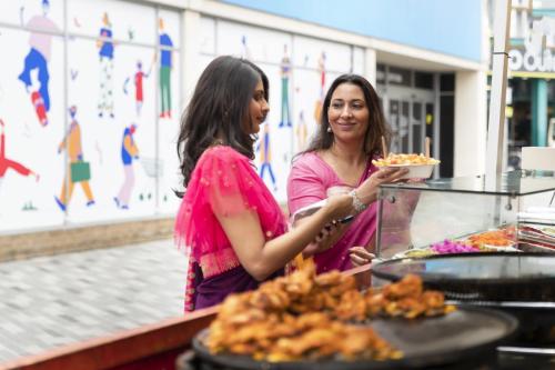 side-view-women-buying-food